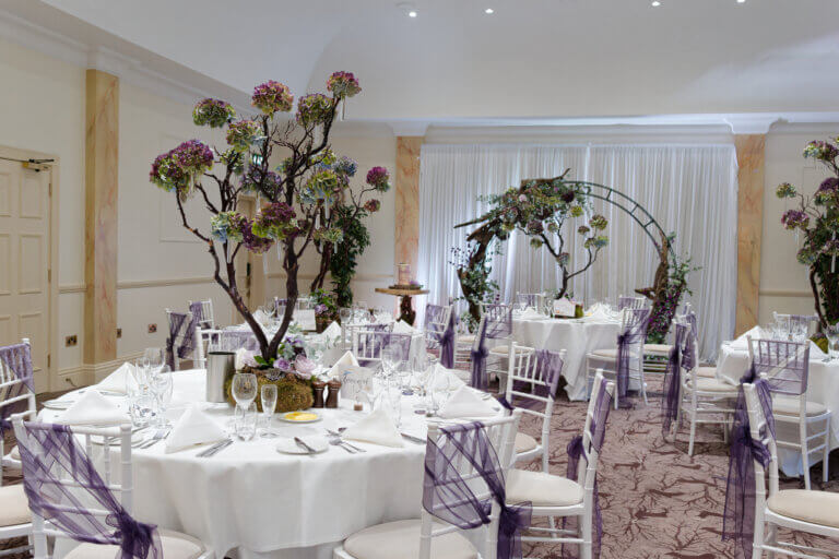 Cedar Suite set for the wedding breakfast with purple floral arrangements and the moon gare