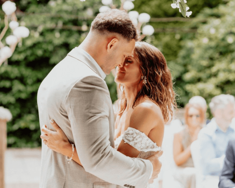 the bride and groom embrace at the end of the wedding ceremony