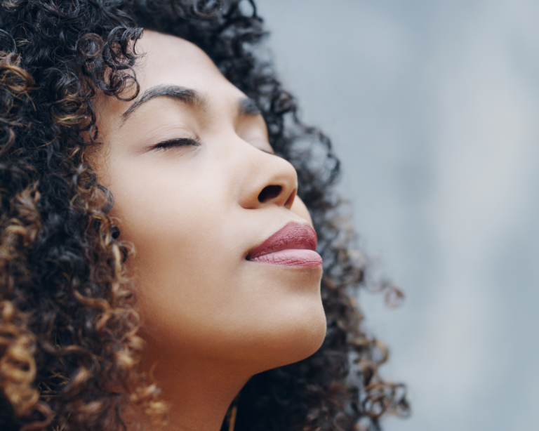 Woman closes eyes for mindful meditation - Mind Chi at Careys Manor