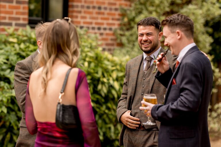 Guests smile and talk outside the front of Careys Manor