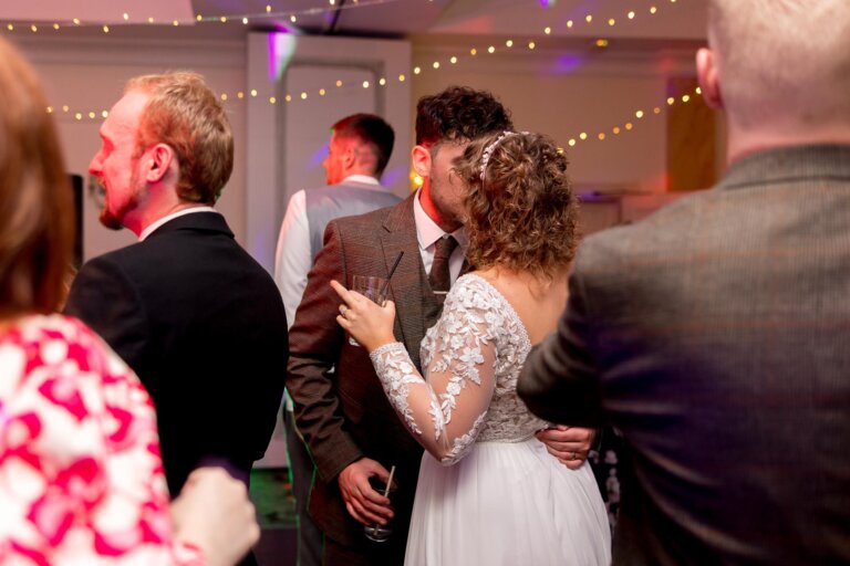 Bride and groom share a kiss on the dance floor